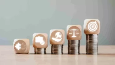 Monedas amontonadas con distintos valores corporativos.